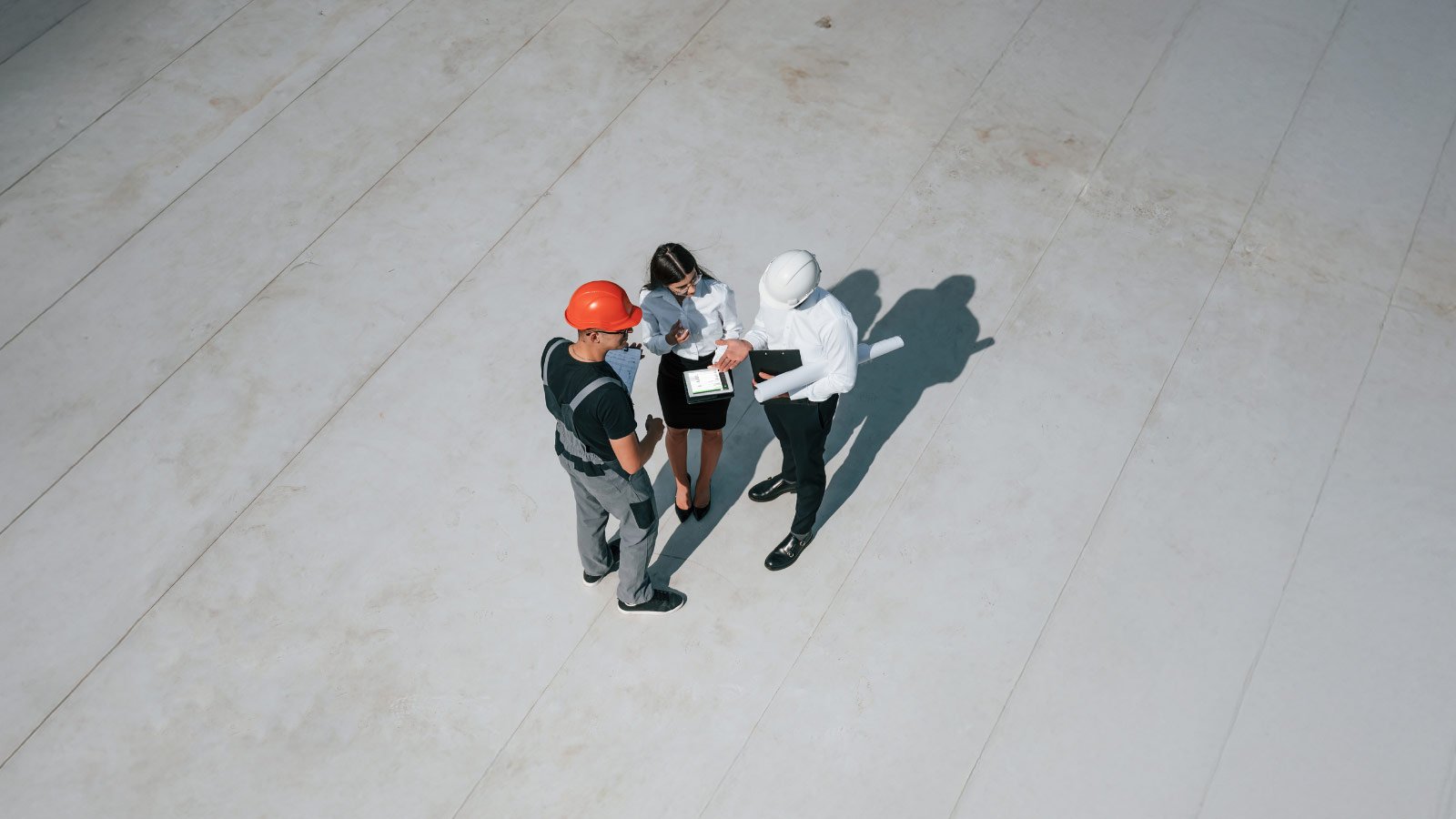 architect, contractor, and project manager having a conversation